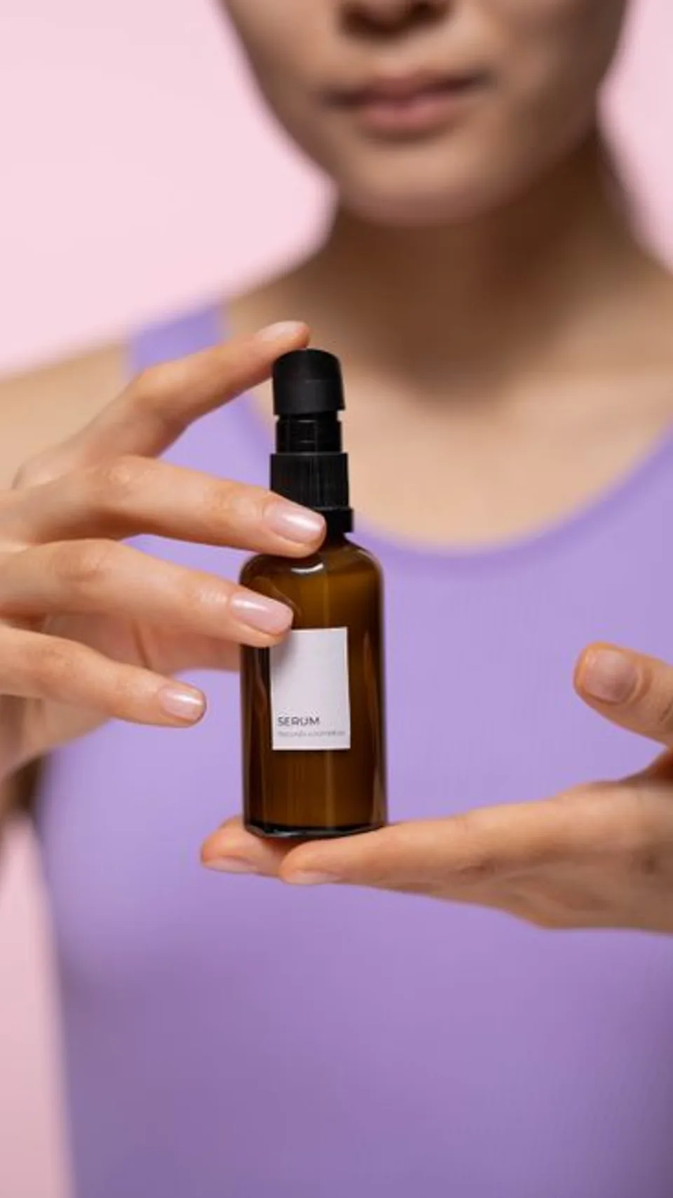 A creator demonstrating a serum bottle
